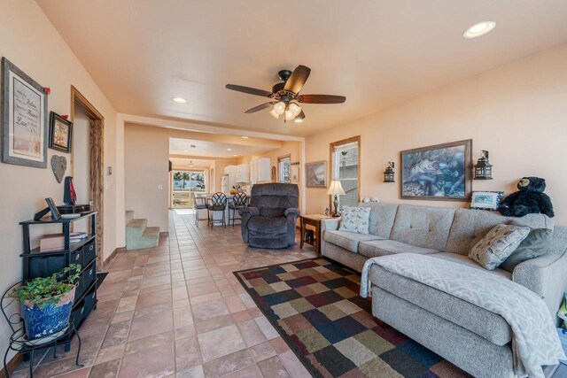 living room with stairway, recessed lighting, and ceiling fan