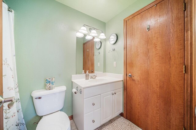 bathroom featuring toilet and vanity