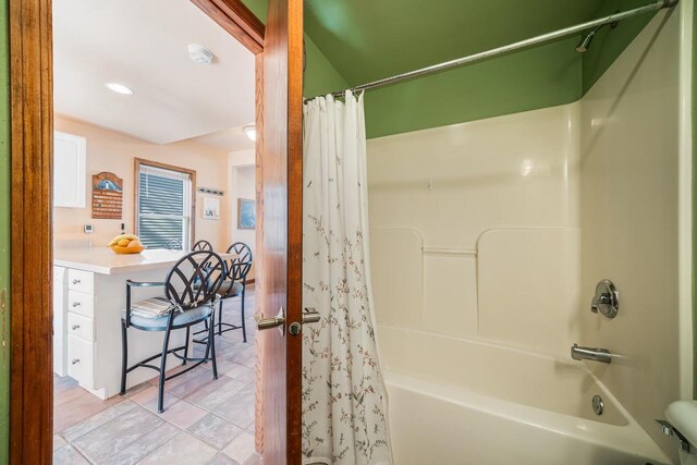 bathroom featuring shower / bath combination with curtain