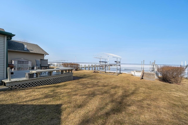 view of yard with a deck with water view