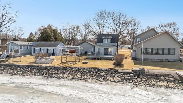 view of front facade with a front yard and a wooden deck