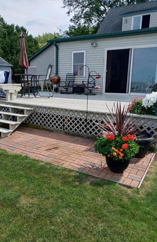 rear view of house featuring a wooden deck