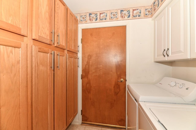 laundry room featuring cabinet space and washing machine and dryer