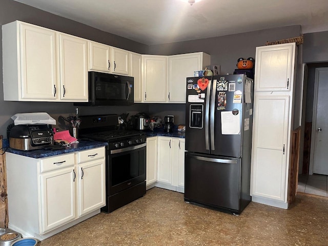 kitchen featuring dark countertops, black appliances, and white cabinetry