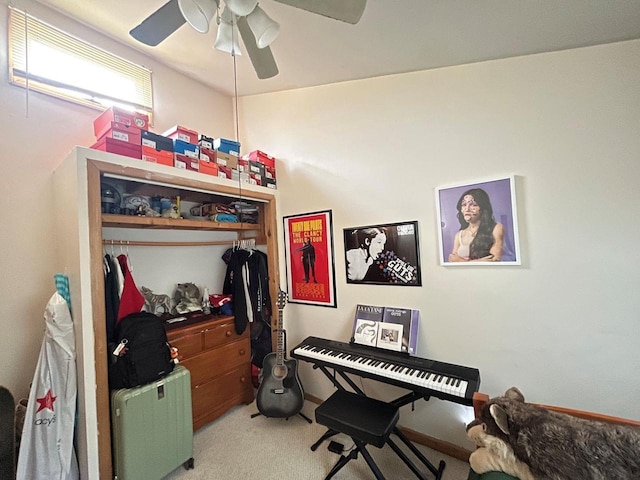 interior space with light carpet and a ceiling fan