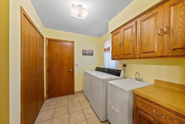 37 E Shore Dr, Random Lake, WI 53075 - laundry room with washer and dryer, light tile patterned floors, cabinet space, and a sink