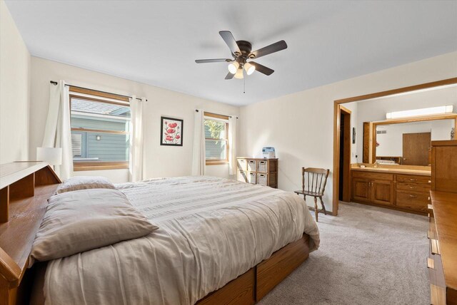 37 E Shore Dr, Random Lake, WI 53075 - bedroom featuring connected bathroom, light carpet, and a ceiling fan