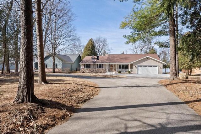 37 E Shore Dr, Random Lake, WI 53075 - ranch-style home featuring a garage and aphalt driveway