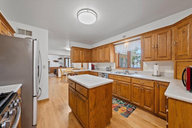 37 E Shore Dr, Random Lake, WI 53075 - kitchen with a sink, brown cabinets, appliances with stainless steel finishes, and a center island