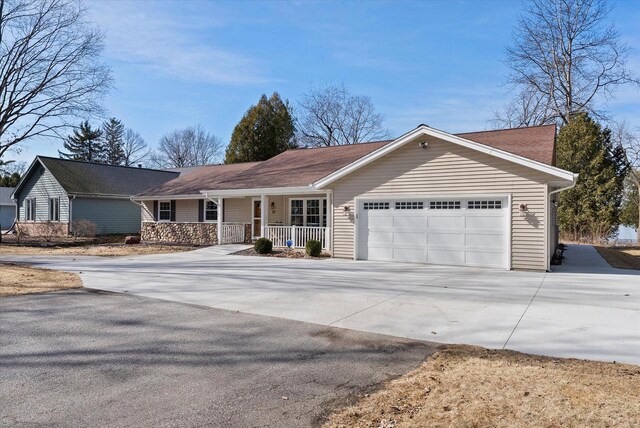 37 E Shore Dr, Random Lake, WI 53075 - single story home featuring a porch, stone siding, a garage, and driveway