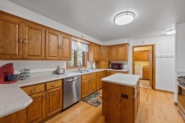 37 E Shore Dr, Random Lake, WI 53075 - kitchen featuring light countertops, light wood-style flooring, appliances with stainless steel finishes, brown cabinetry, and a sink