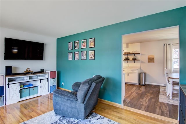 living room featuring baseboards and wood finished floors