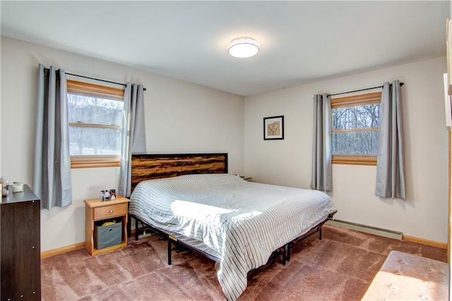 bedroom featuring carpet flooring, a baseboard heating unit, and baseboards