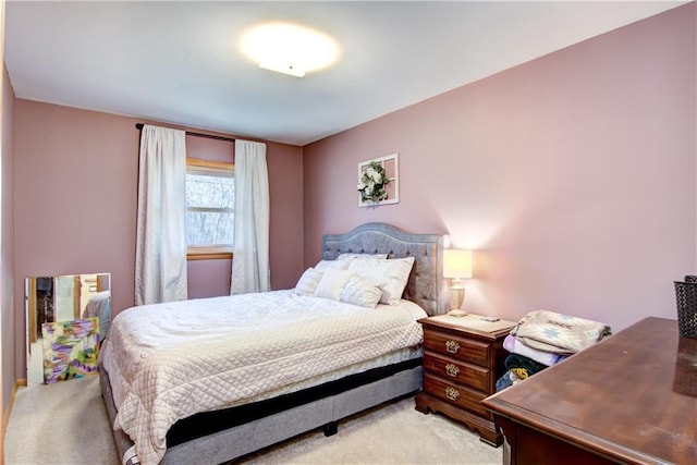 bedroom featuring light carpet