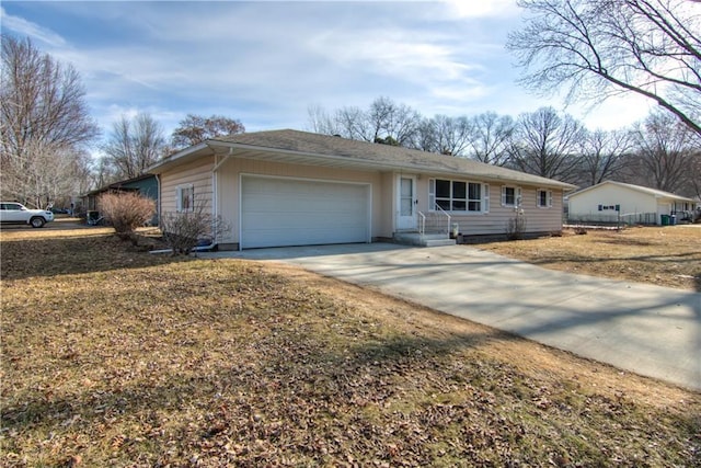 ranch-style house with a garage and concrete driveway