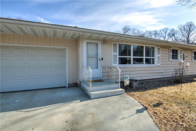 single story home featuring concrete driveway and a garage