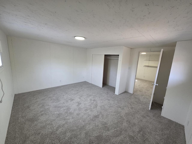 unfurnished bedroom featuring a closet and carpet floors