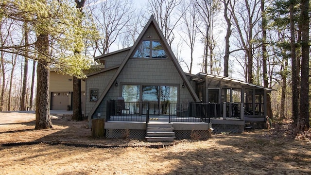 204629 Lake Dr, Rosholt, WI 54473 - rear view of house with a garage, a wooden deck, and a sunroom