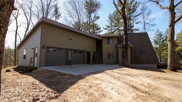 204629 Lake Dr, Rosholt, WI 54473 - view of property exterior featuring an attached garage and driveway