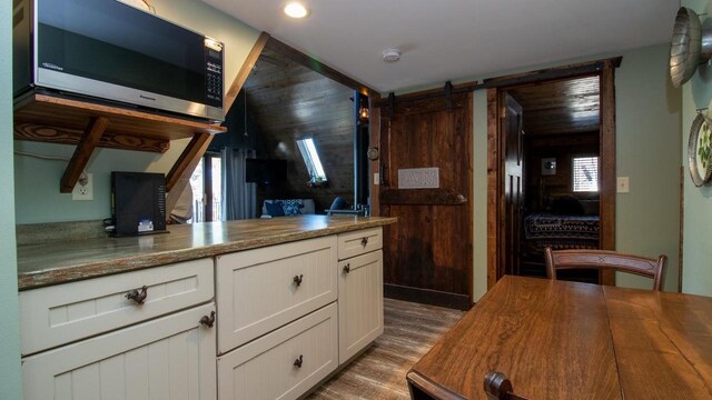 204629 Lake Dr, Rosholt, WI 54473 - kitchen featuring white cabinetry, wooden walls, wood finished floors, and wood counters