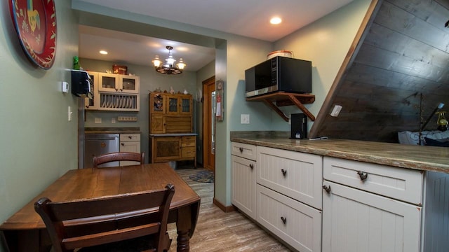 204629 Lake Dr, Rosholt, WI 54473 - kitchen with glass insert cabinets, a chandelier, light wood-style floors, white cabinets, and fridge