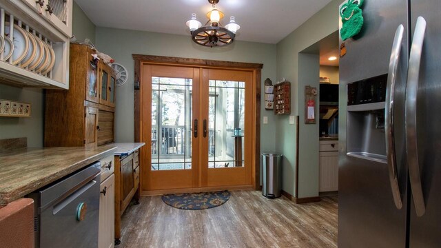 204629 Lake Dr, Rosholt, WI 54473 - entryway with french doors, baseboards, an inviting chandelier, and light wood-style flooring