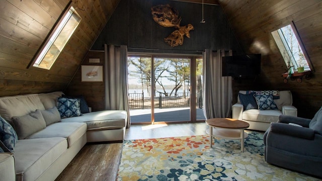 204629 Lake Dr, Rosholt, WI 54473 - living room with wooden walls, vaulted ceiling with skylight, wooden ceiling, and wood finished floors