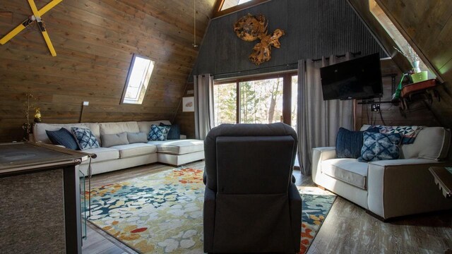 204629 Lake Dr, Rosholt, WI 54473 - living room with a skylight, wooden walls, wood finished floors, and high vaulted ceiling