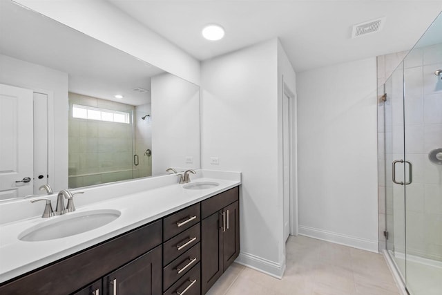 1251 Denmark Cir, Oregon, WI 53575 - bathroom with a shower stall, double vanity, visible vents, and a sink