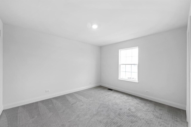 1251 Denmark Cir, Oregon, WI 53575 - carpeted spare room featuring visible vents and baseboards