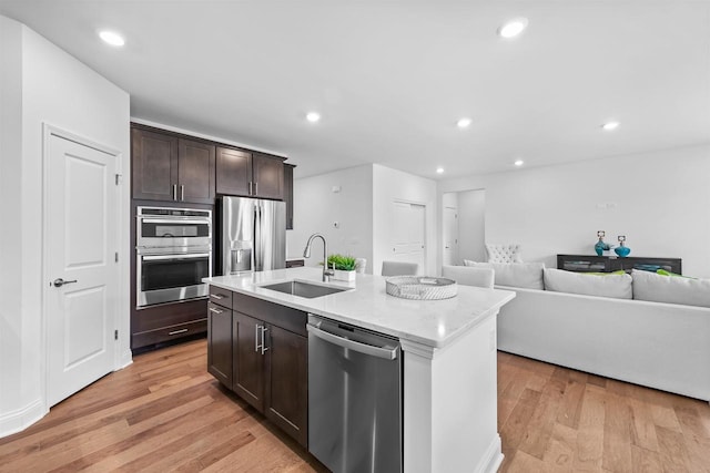 1251 Denmark Cir, Oregon, WI 53575 - kitchen featuring a sink, open floor plan, recessed lighting, stainless steel appliances, and light wood finished floors