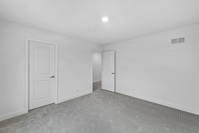 1251 Denmark Cir, Oregon, WI 53575 - unfurnished bedroom with carpet flooring, baseboards, and visible vents