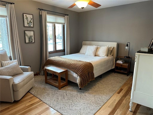 bedroom with light wood finished floors and ceiling fan