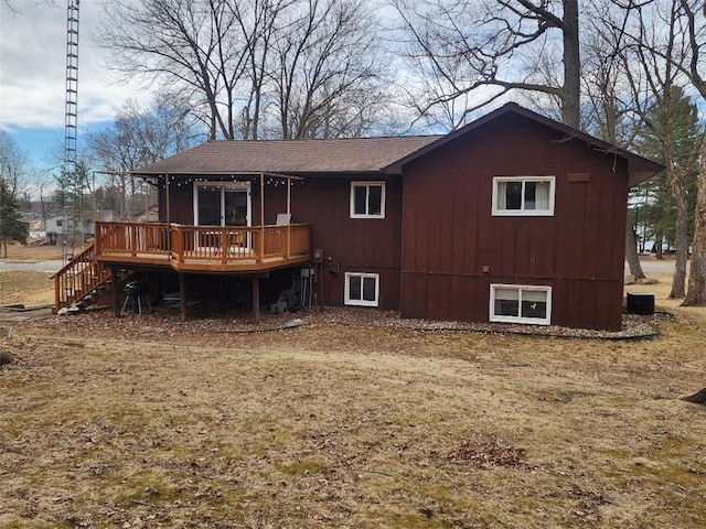 rear view of property featuring stairway and a wooden deck