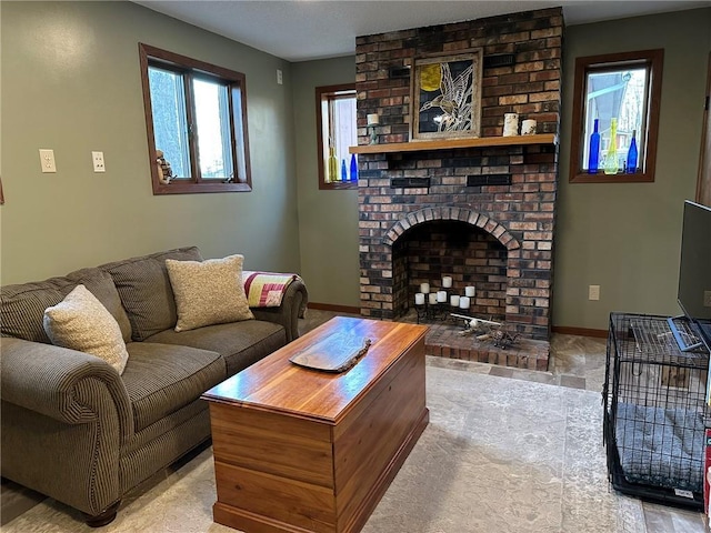 living area with baseboards and a fireplace