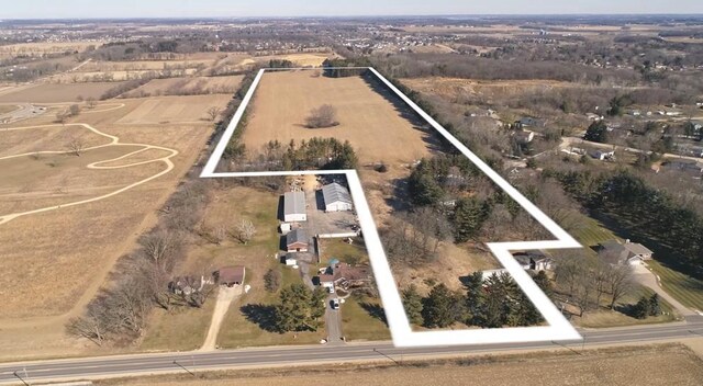 birds eye view of property with a rural view