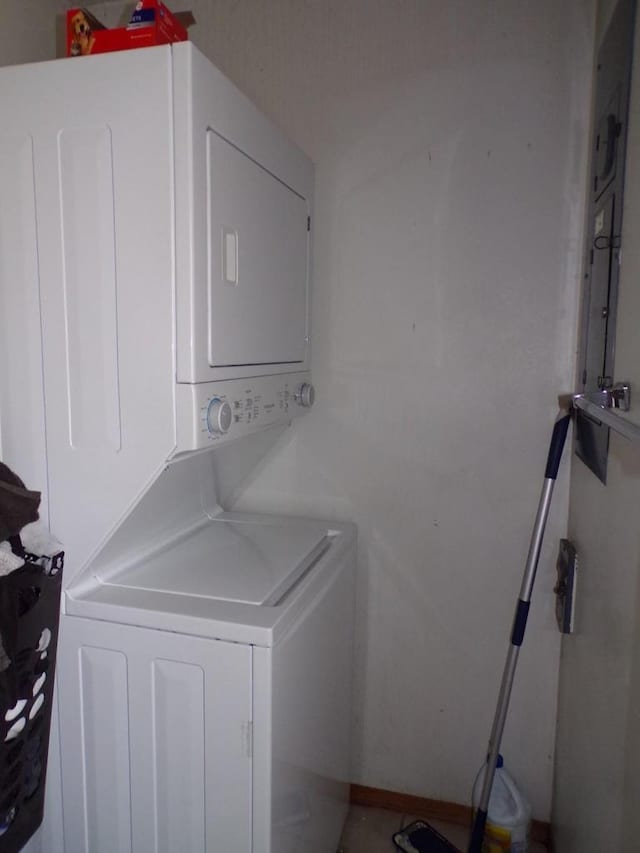 laundry room featuring laundry area and stacked washer / dryer