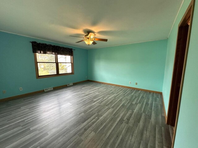 20530 84th Pl, Bristol, WI 53104 - spare room featuring dark wood-style floors, a ceiling fan, visible vents, and baseboards