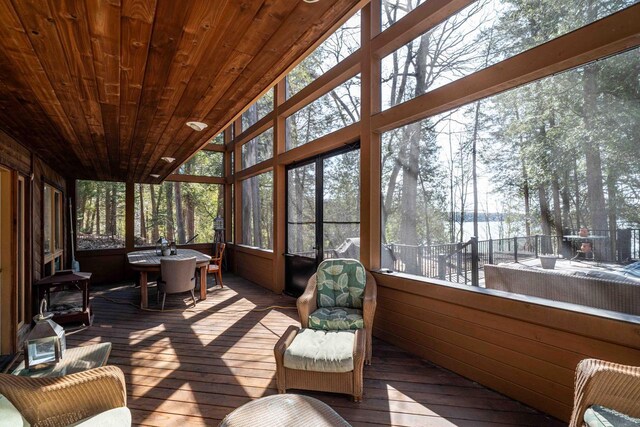 sunroom featuring outdoor dining area