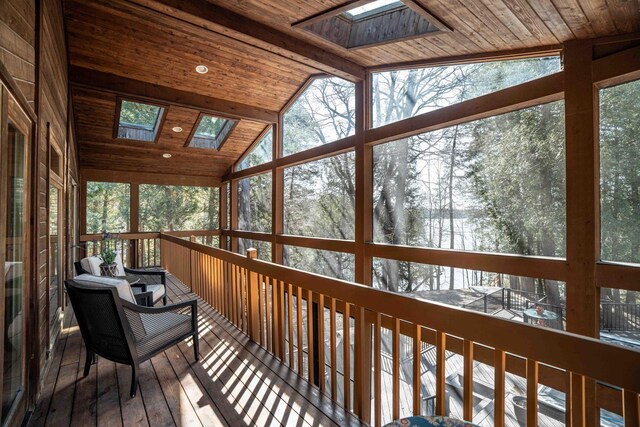 sunroom featuring a wealth of natural light and a skylight