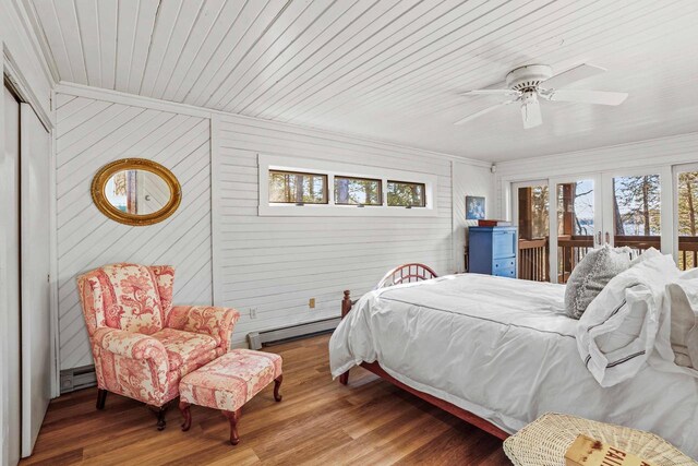 bedroom with wooden ceiling, a baseboard radiator, ceiling fan, crown molding, and wood finished floors