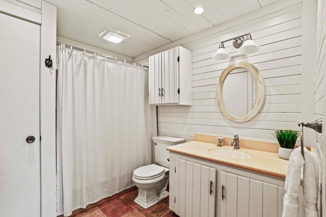 bathroom featuring vanity, tile patterned flooring, a shower with curtain, toilet, and wood walls