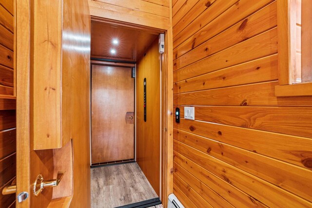 interior space featuring wooden walls and wood finished floors