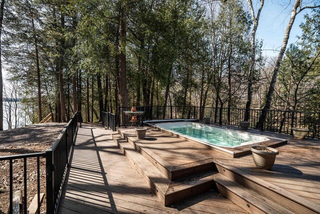 view of swimming pool with a deck