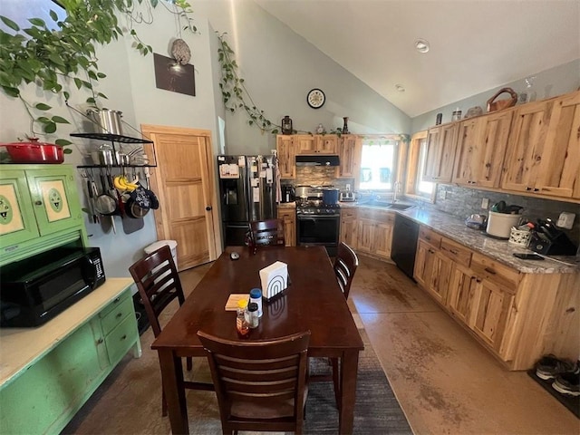 dining space with a toaster and high vaulted ceiling