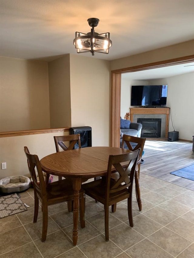 tiled dining room with a fireplace