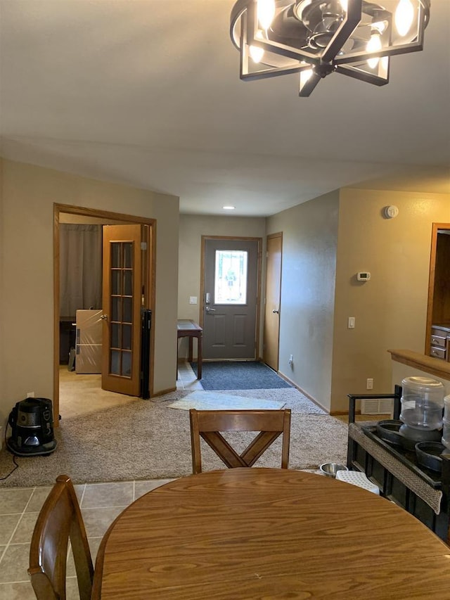 tiled dining space with carpet and baseboards