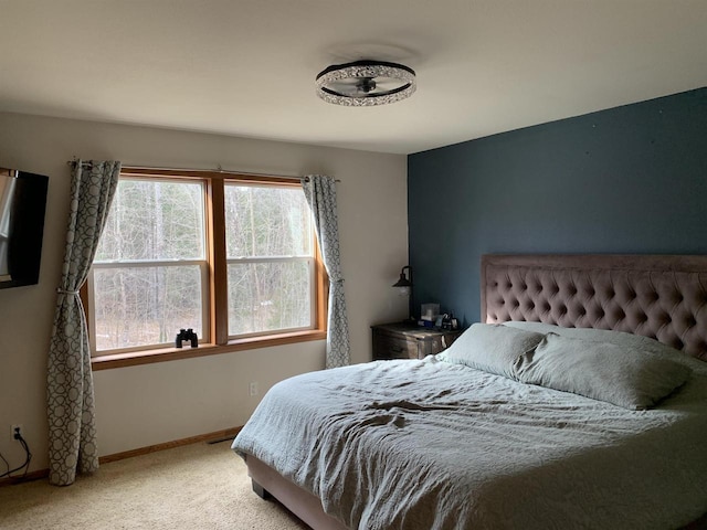 carpeted bedroom featuring baseboards