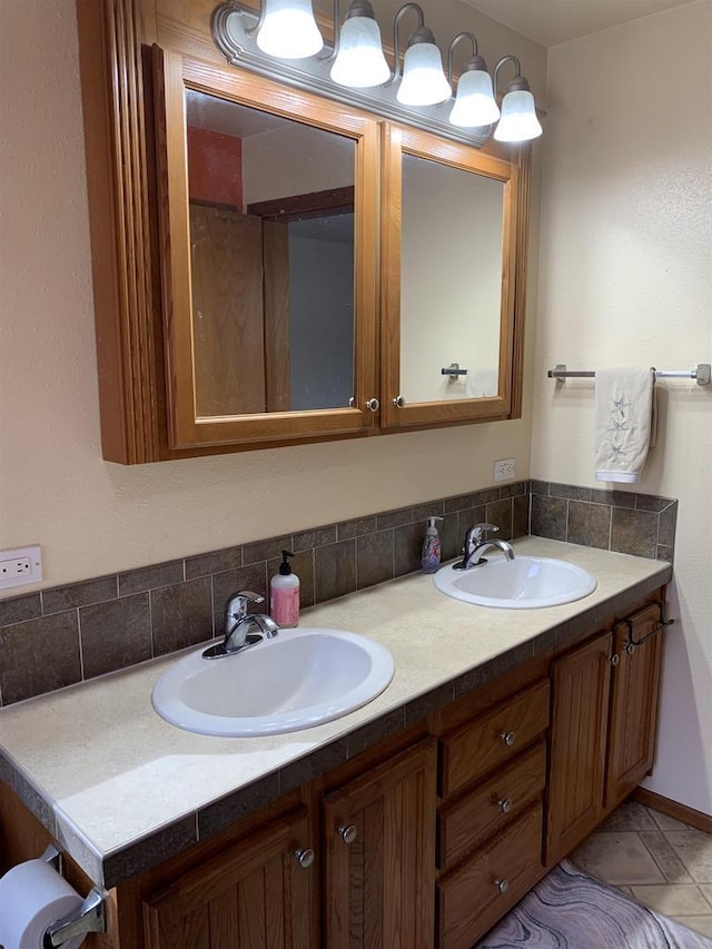 bathroom featuring double vanity, decorative backsplash, and a sink