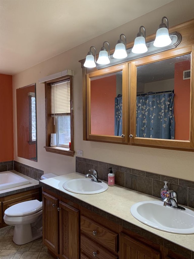 bathroom with a sink, visible vents, and double vanity